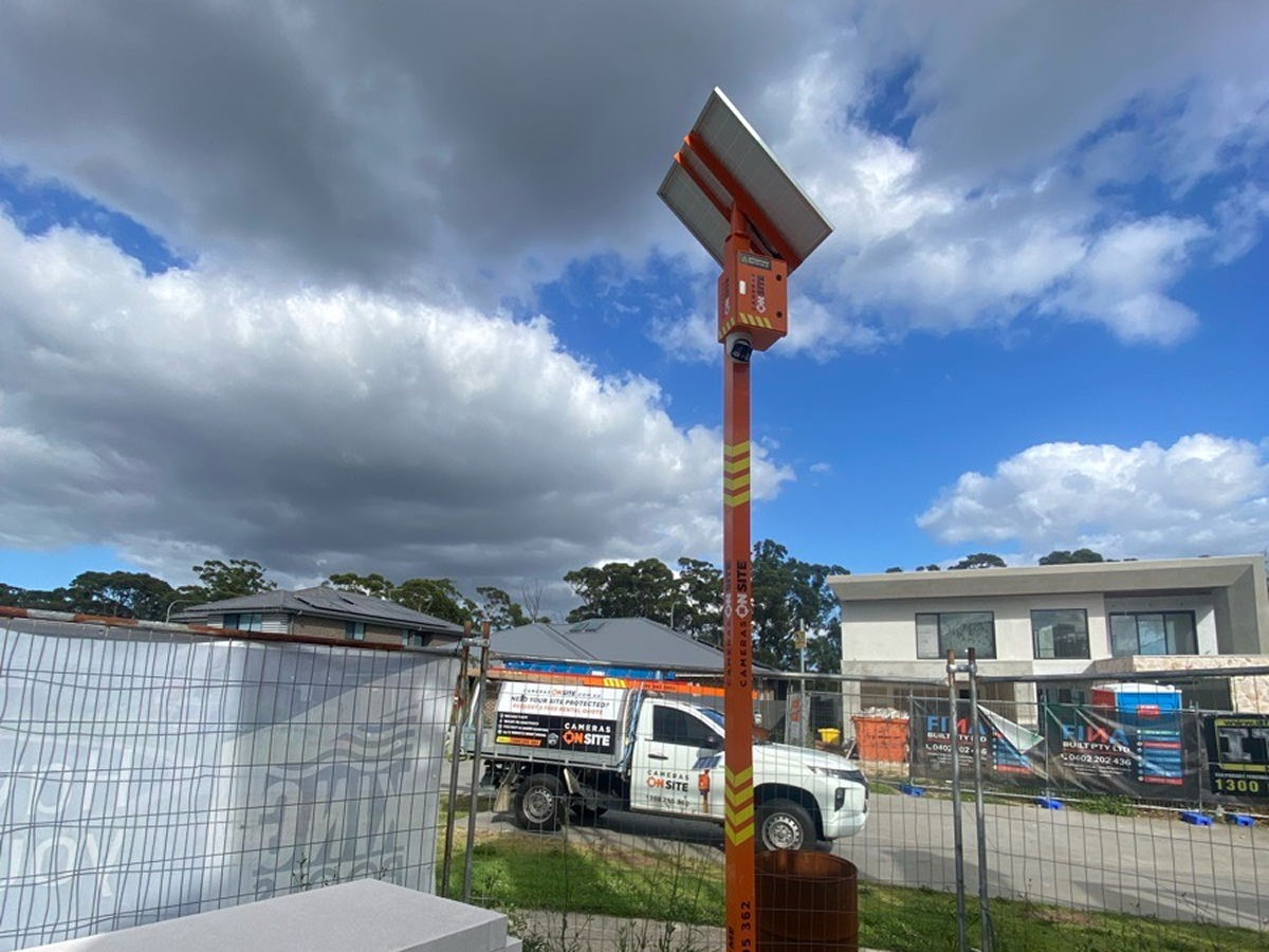 Construction site with Cameras On Site solar powered security camera tower installed for remote monitoring and theft prevention